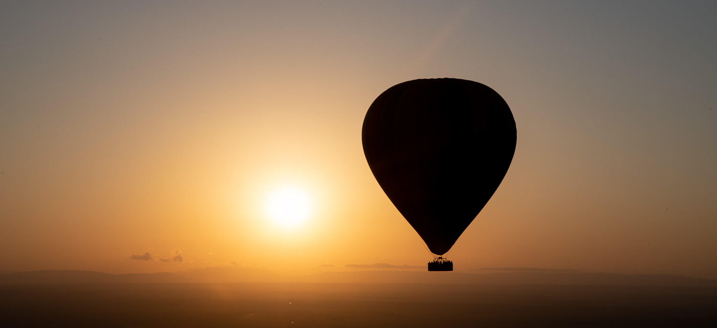 Hot air balloon floating above the Serengeti during a 4-Day Tarangire, Serengeti & Ngorongoro Safari.