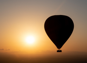Hot air balloon floating above the Serengeti during a 4-Day Tarangire, Serengeti & Ngorongoro Safari.