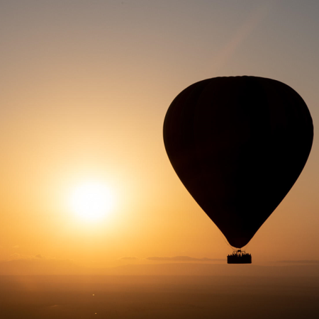 Hot air balloon floating above the Serengeti during a 4-Day Tarangire, Serengeti & Ngorongoro Safari.