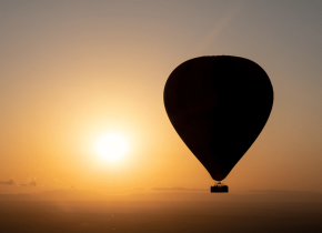 Hot air balloon floating above the Serengeti during a 4-Day Tarangire, Serengeti & Ngorongoro Safari.