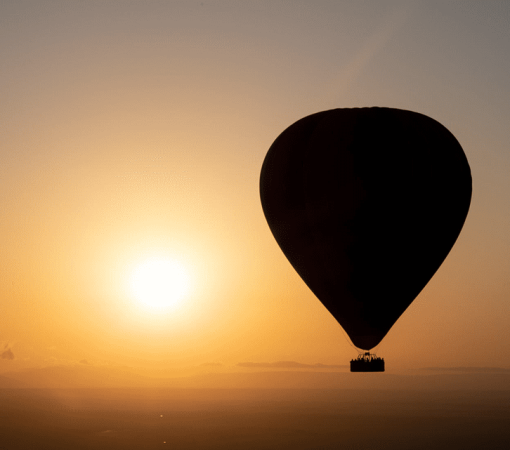 Hot air balloon floating above the Serengeti during a 4-Day Tarangire, Serengeti & Ngorongoro Safari.