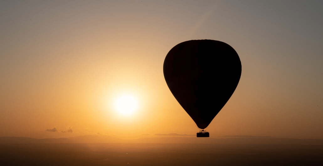Hot air balloon floating above the Serengeti during a 4-Day Tarangire, Serengeti & Ngorongoro Safari.